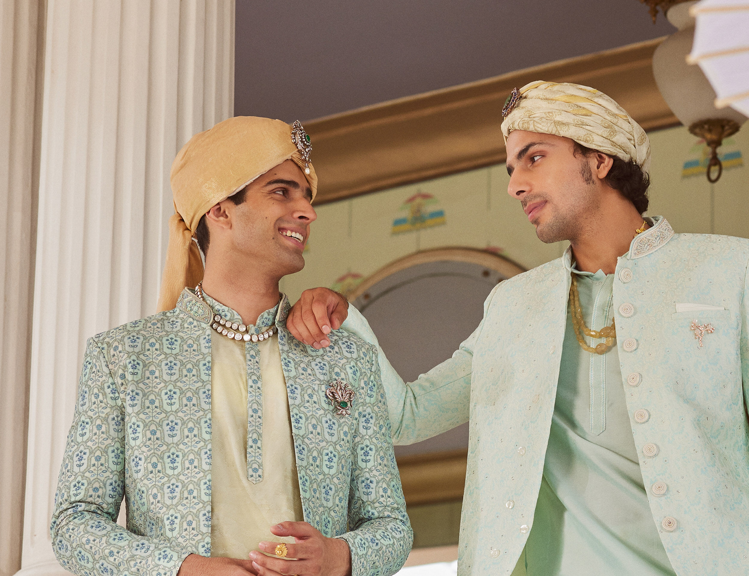  Boys wearing golden and white Rajputi safas for a traditional Indian wedding celebration